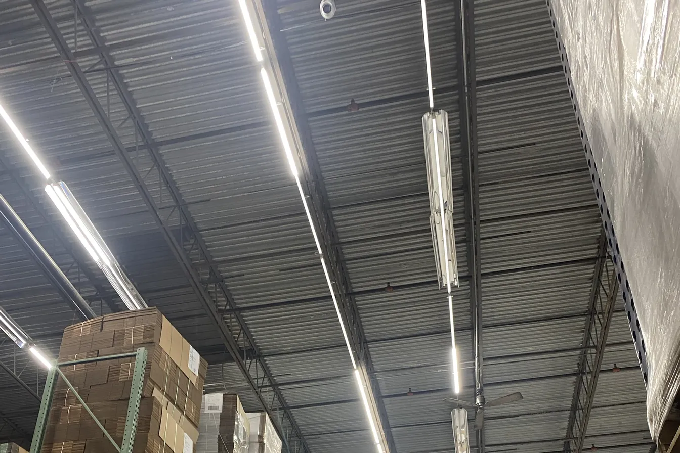 Modern dome security camera mounted on a warehouse ceiling