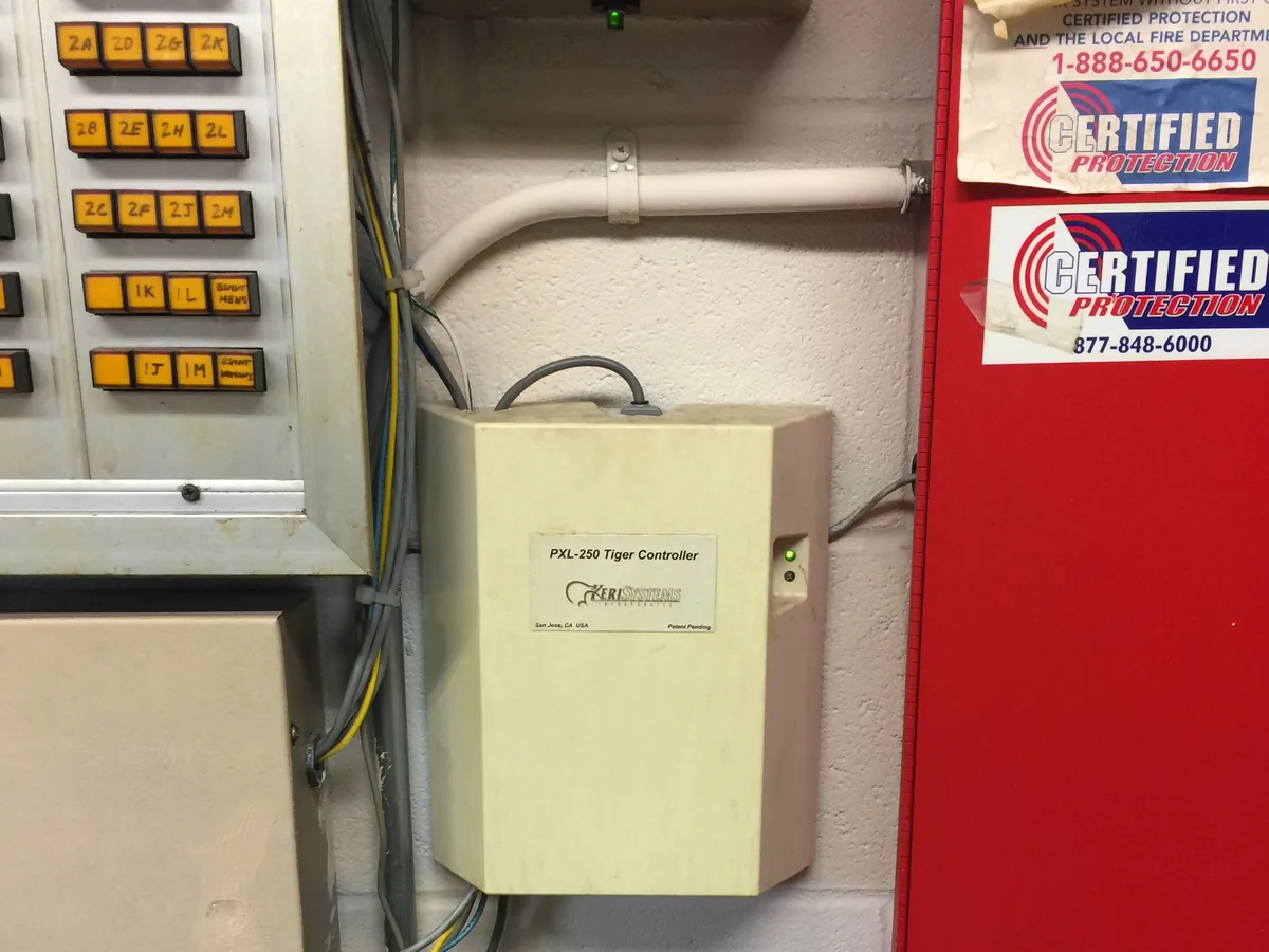 Keri Systems PXL-250 access control head end wired alongside the fire alarm panel