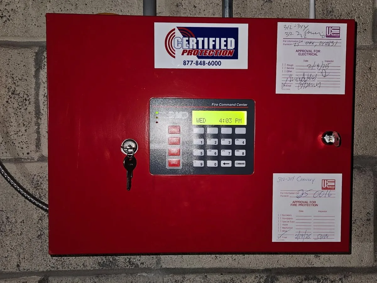 DMP fire command center installed by Certified Protection with NJ electrical and fire protection approval tags