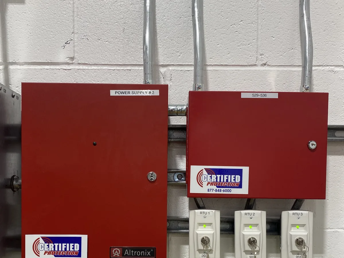 Fire alarm power supply enclosure and labeled RTU key switches in a New Jersey commercial building